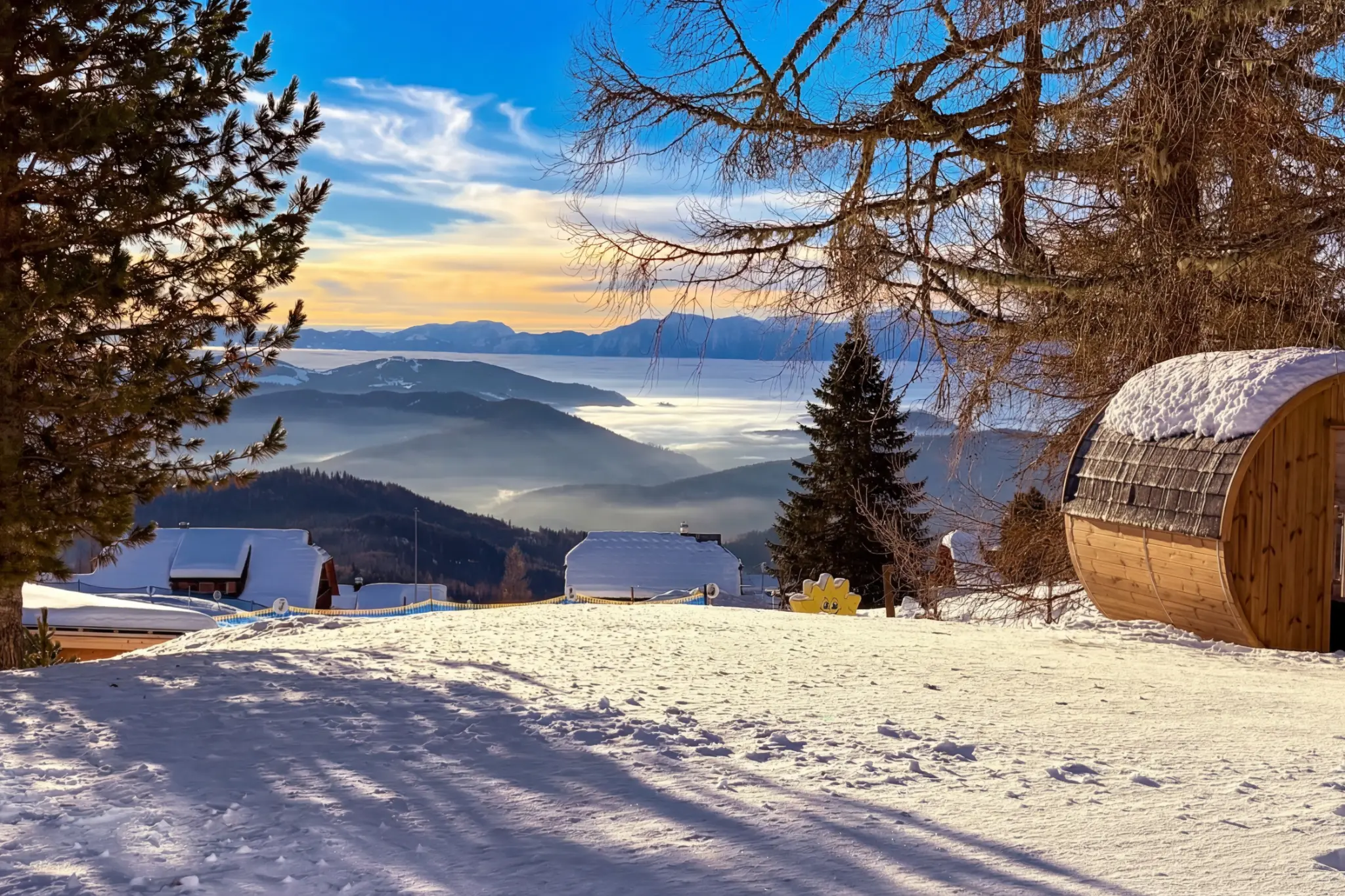 Private Berglodge barrel sauna in the snow with panoramic Nockberge views