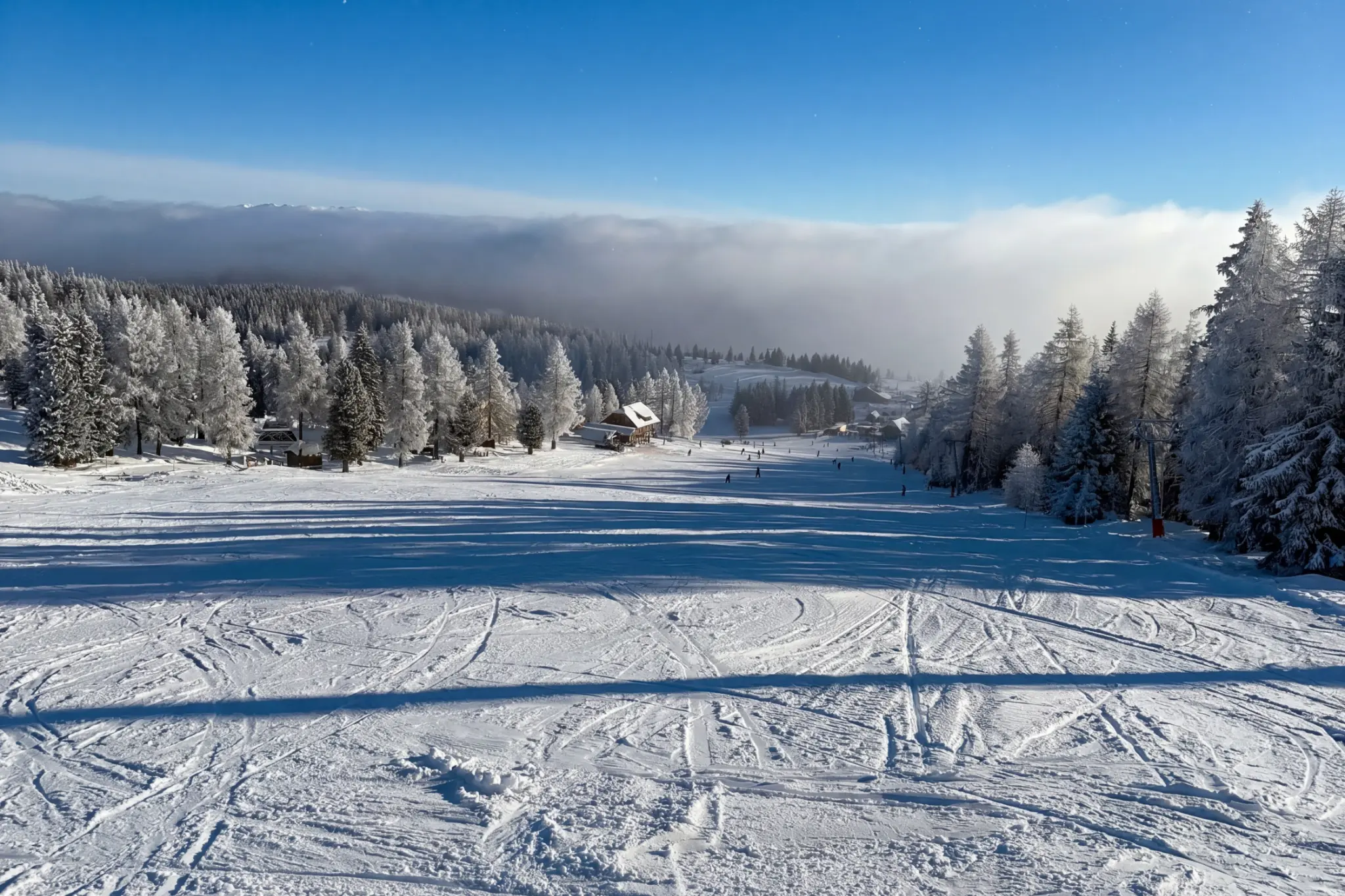 Wide sunny ski slope at Hochrindl in winter